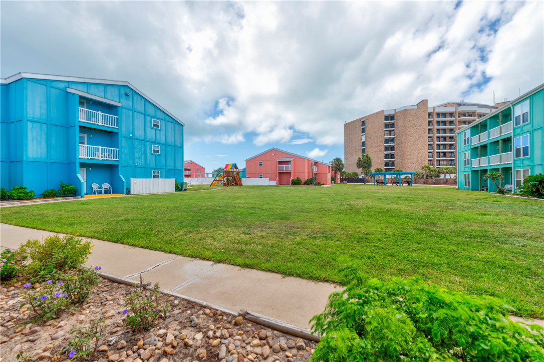 800 Beach Access Road, Unit 111 Port Aransas, TX 78373 - Photo 15 of 30 a view of a big building with big yard and large trees