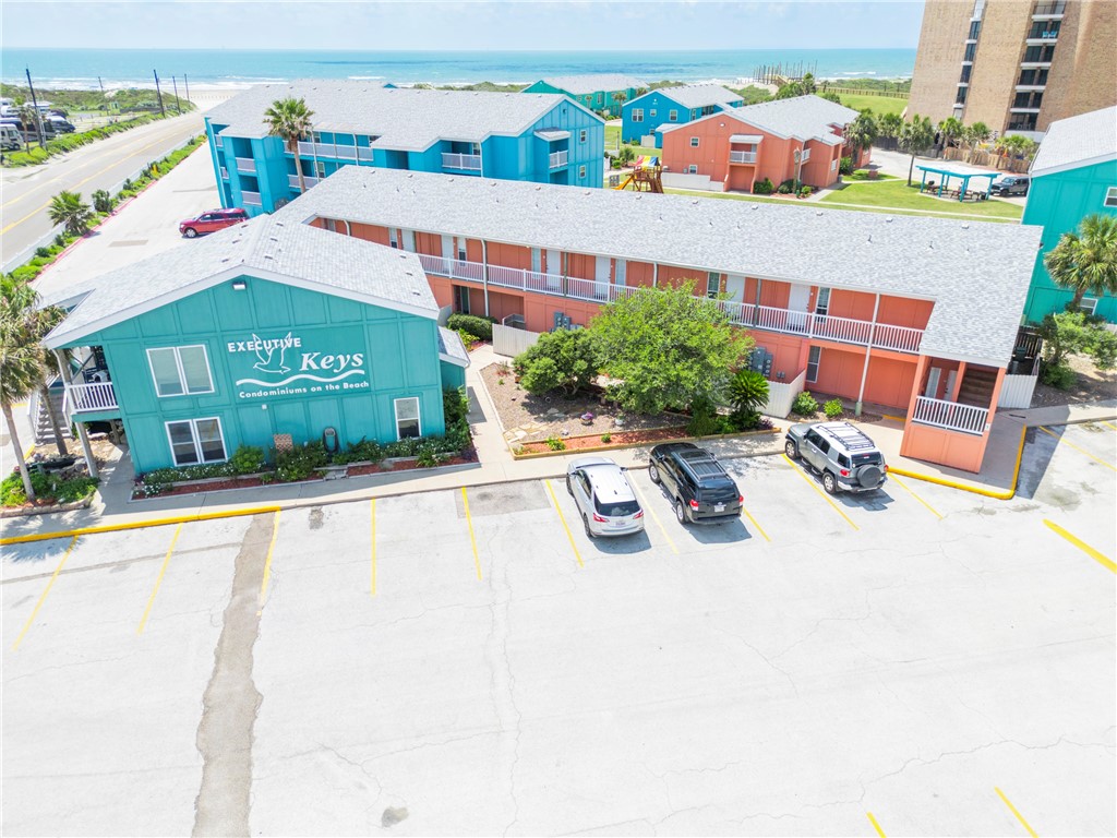 800 Beach Access Road, Unit 111 Port Aransas, TX 78373 - Photo 30 of 30 a view of a patio with a table and chairs under an umbrella