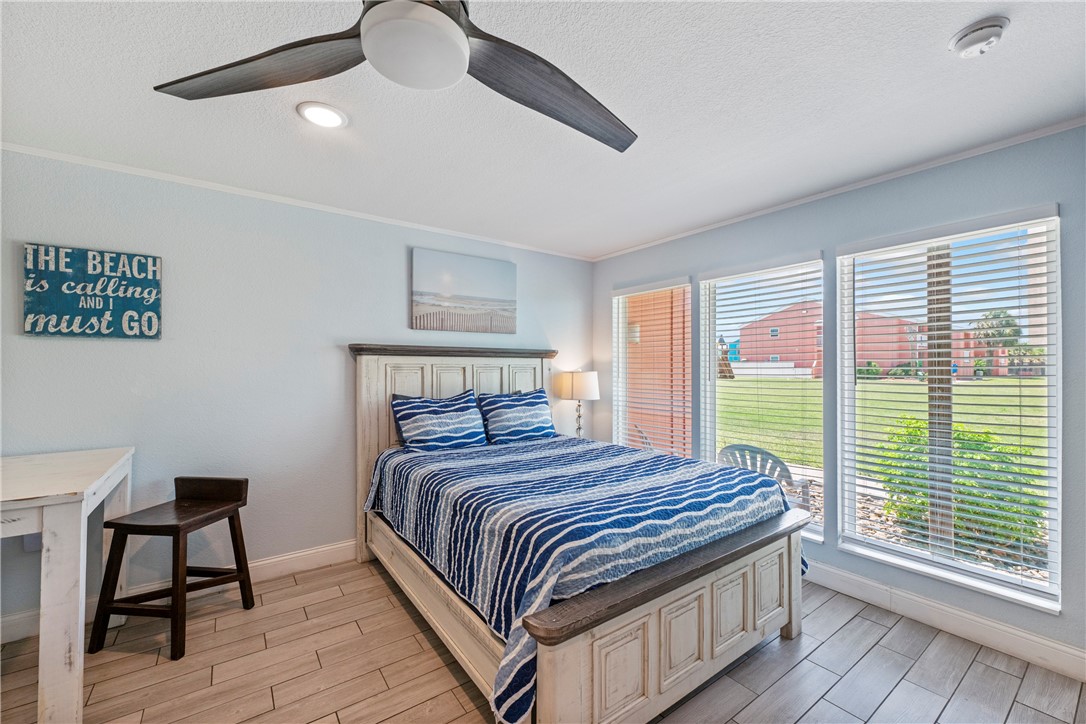 800 Beach Access Road, Unit 111 Port Aransas, TX 78373 - Photo 4 of 30 a bedroom with a large bed and a large window