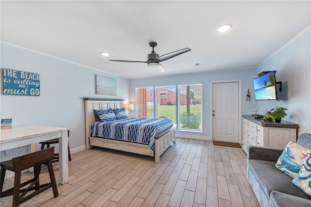800 Beach Access Road, Unit 111 Port Aransas, TX 78373 - Photo 5 of 30 a bedroom with a bed and wooden floor