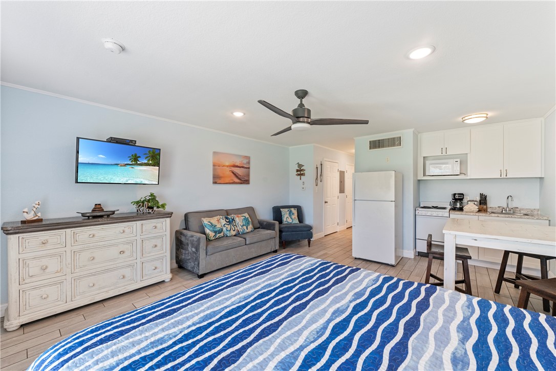 800 Beach Access Road, Unit 111 Port Aransas, TX 78373 - Photo 6 of 30 a bedroom with furniture and a rug