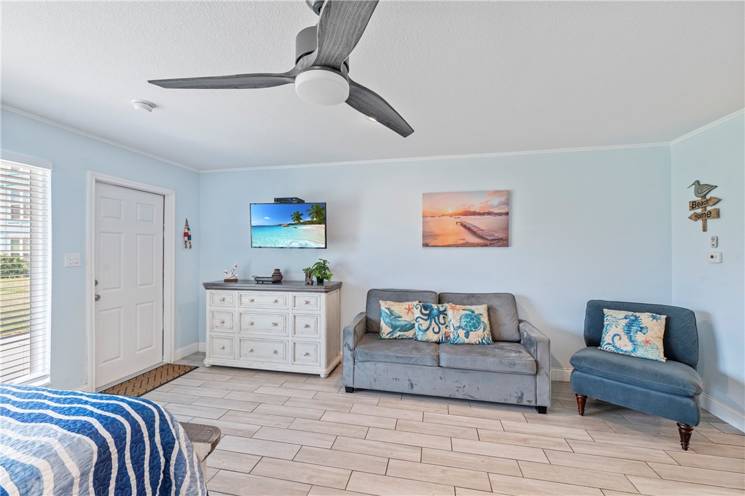 800 Beach Access Road, Unit 111 Port Aransas, TX 78373 - Photo 7 of 30 a bedroom with a bed and a couch