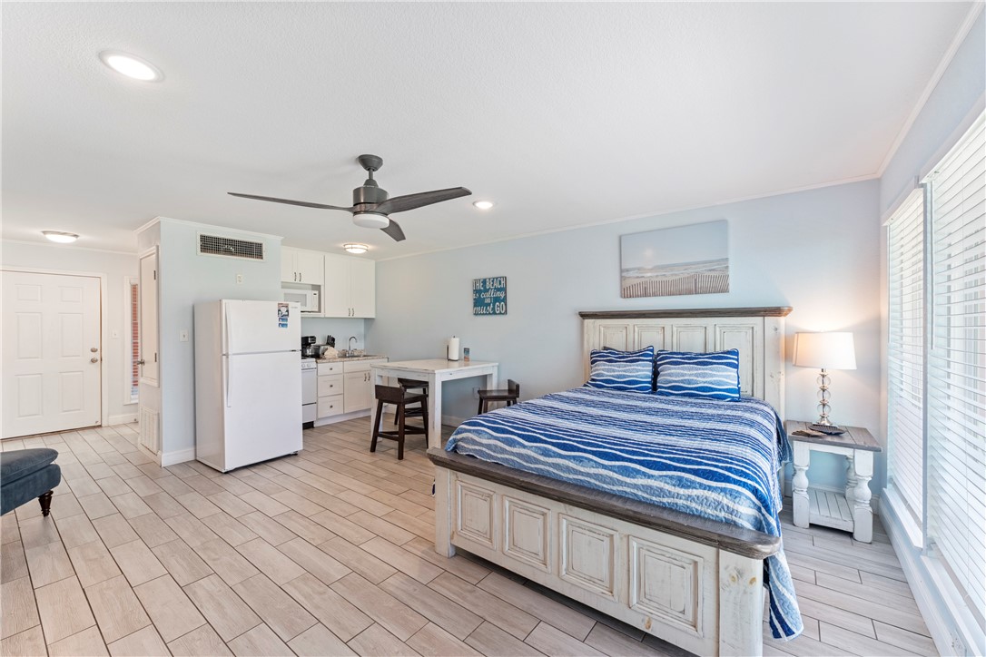 800 Beach Access Road, Unit 111 Port Aransas, TX 78373 - Photo 8 of 30 a bedroom with a bed and a view of kitchen