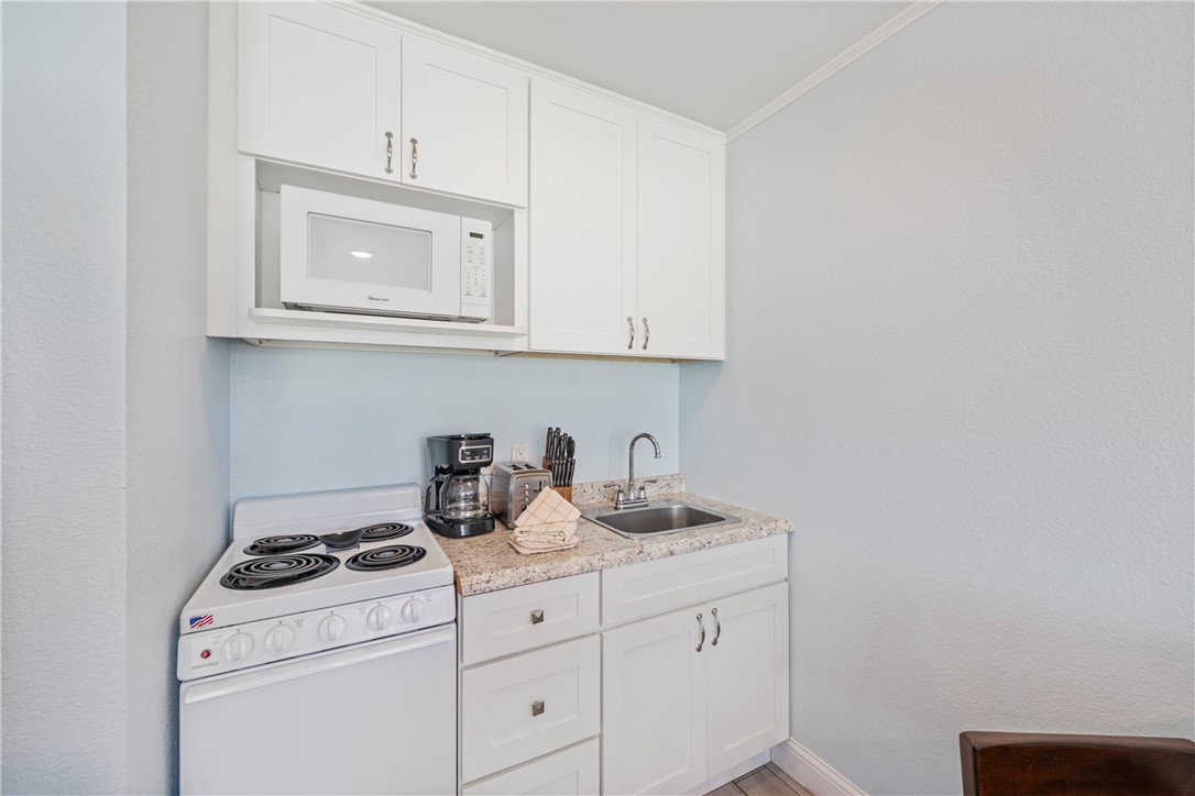 800 Beach Access Road, Unit 111 Port Aransas, TX 78373 - Photo 10 of 30 a view of cabinets and washer dryer