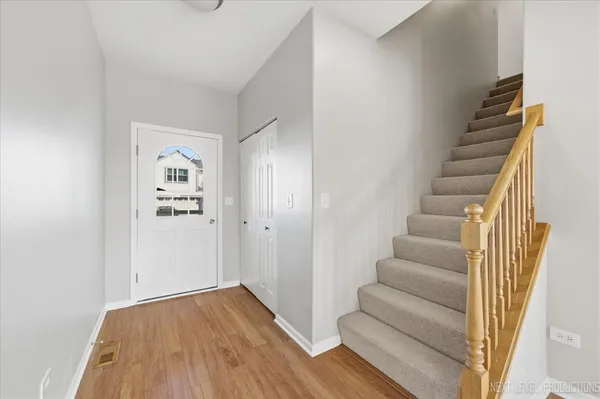 a view of an entryway with wooden floor