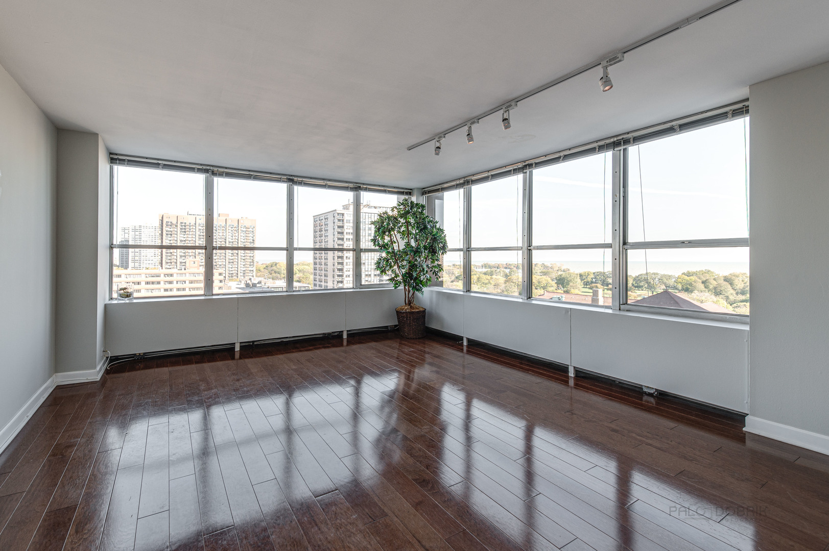 655 West Irving Park Road, Unit 1110 Chicago, IL 60613 - Photo 12 of 30 a view of an empty room with wooden floor and a window
