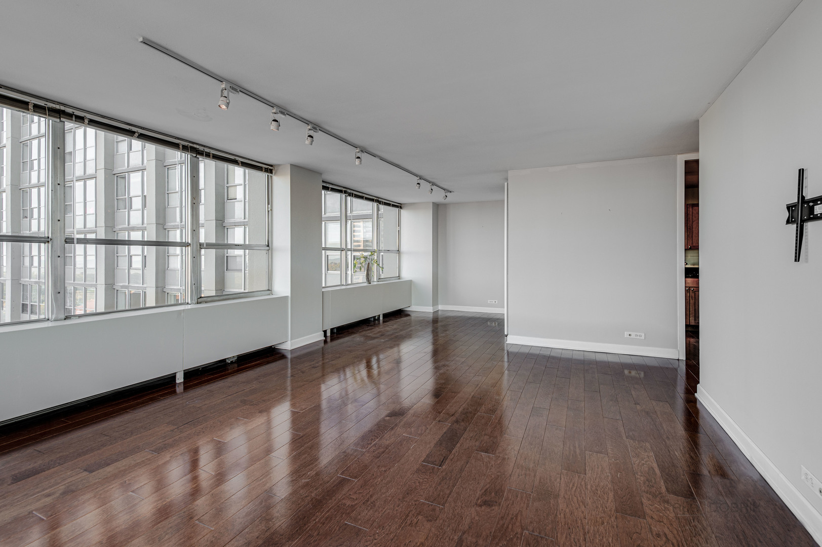 655 West Irving Park Road, Unit 1110 Chicago, IL 60613 - Photo 17 of 30 wooden floor in an empty room with a window