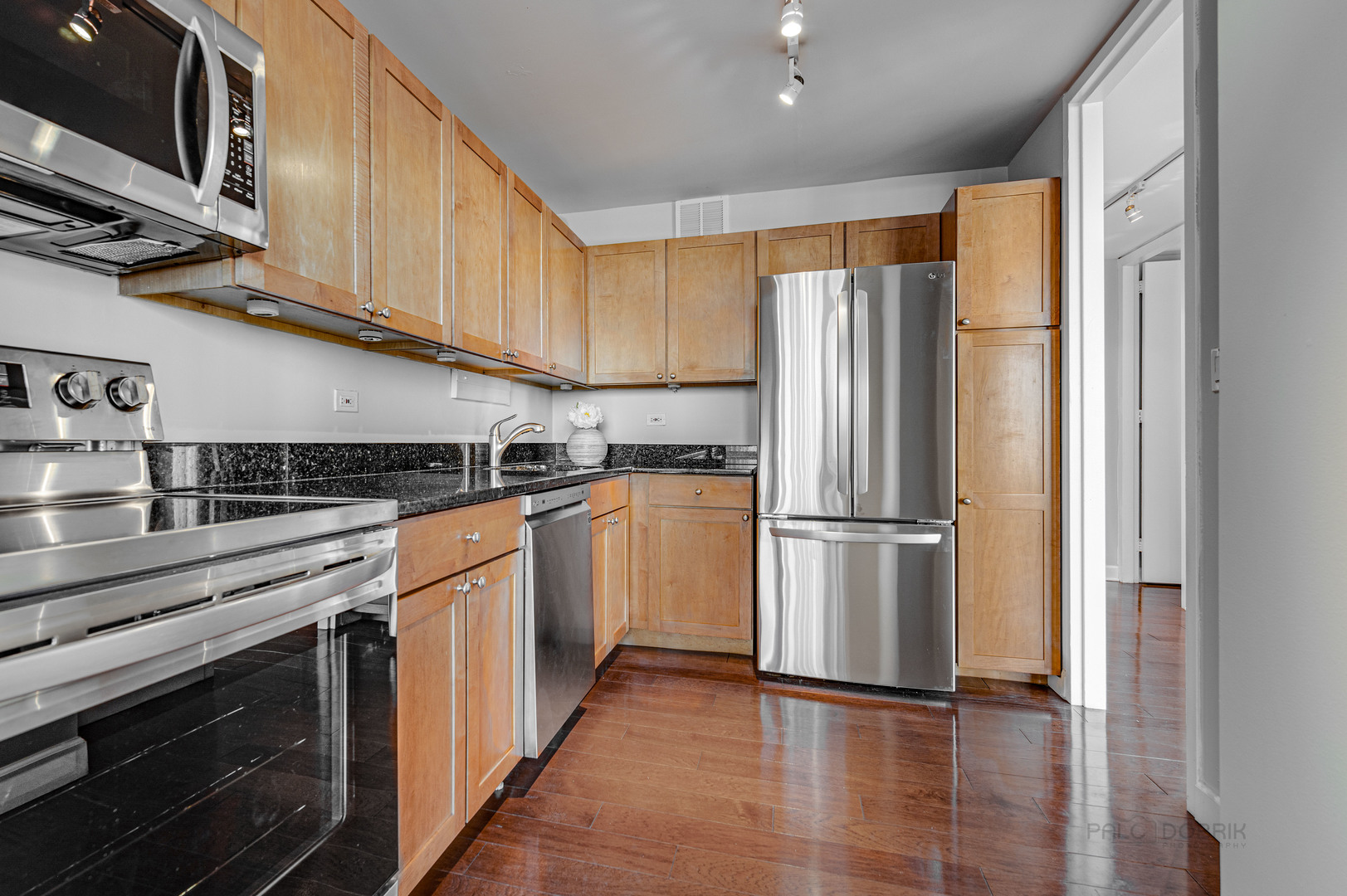 655 West Irving Park Road, Unit 1110 Chicago, IL 60613 - Photo 22 of 30 a kitchen with stainless steel appliances granite countertop a refrigerator and a stove top oven