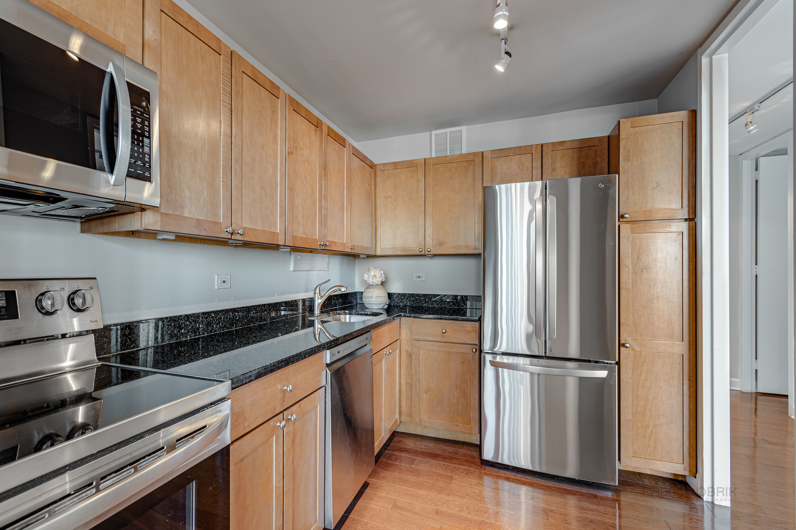 655 West Irving Park Road, Unit 1110 Chicago, IL 60613 - Photo 23 of 30 a kitchen with stainless steel appliances and refrigerator