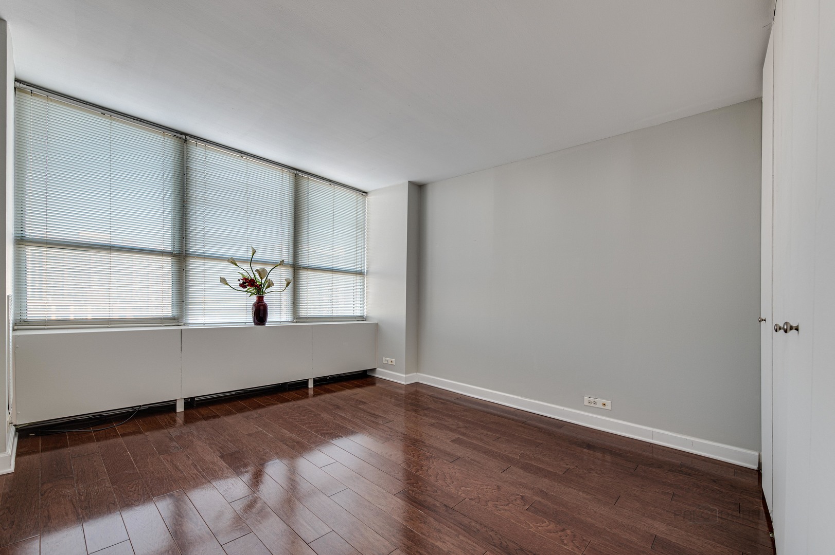 655 West Irving Park Road, Unit 1110 Chicago, IL 60613 - Photo 29 of 30 a view of room with window and wooden floor