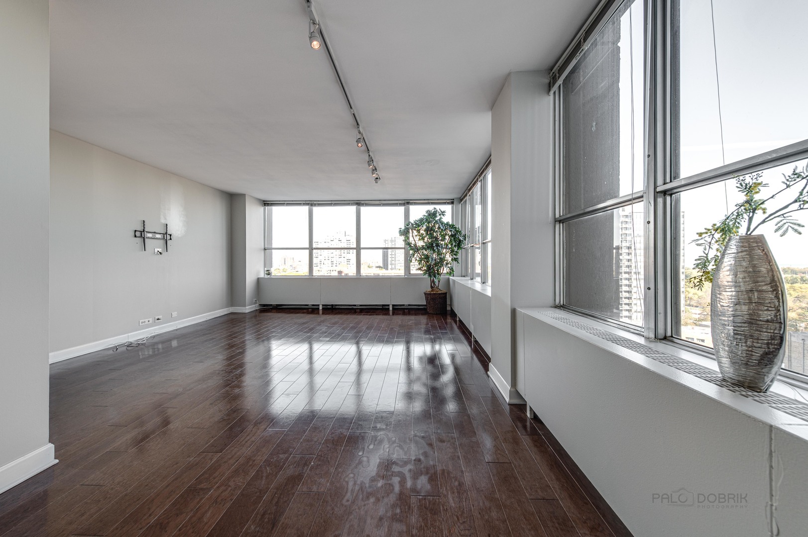 655 West Irving Park Road, Unit 1110 Chicago, IL 60613 - Photo 10 of 30 a view of empty room with wooden floor and fan
