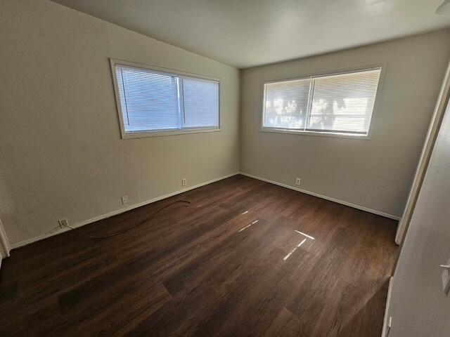 2703 66th Street Lubbock, TX 79413 - Photo 3 of 8 a view of an empty room with wooden floor and a window