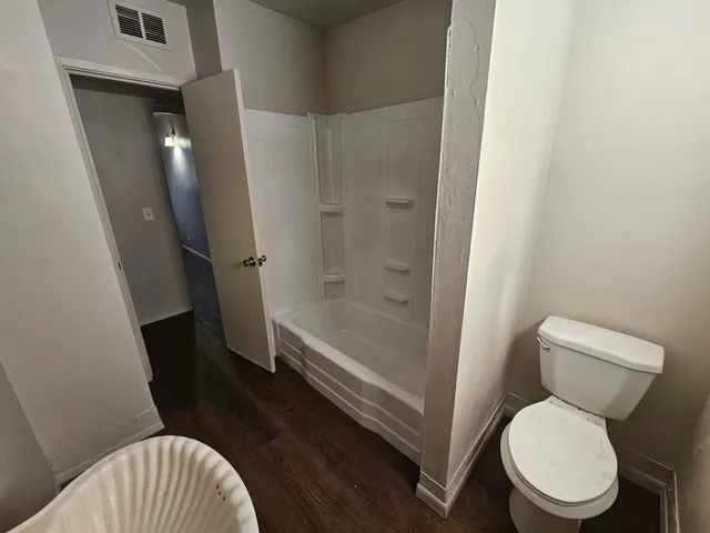a bathroom with a toilet and a shower
