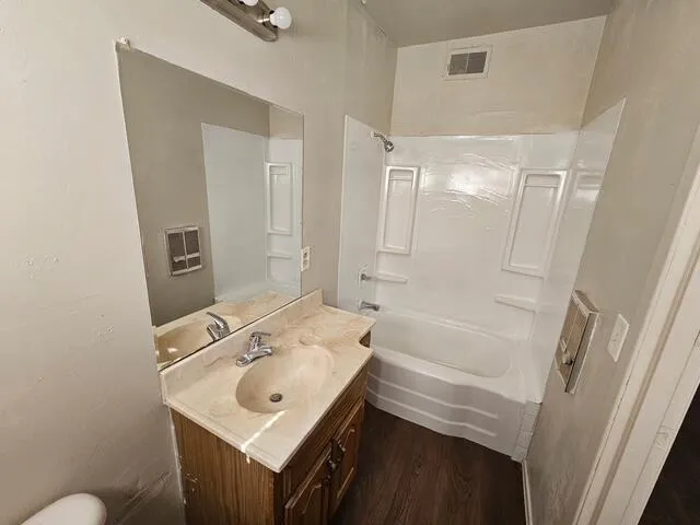 a bathroom with a sink mirror vanity and toilet