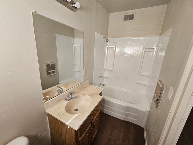 2703 66th Street Lubbock, TX 79413 - Photo 6 of 8 a bathroom with a sink mirror vanity and toilet
