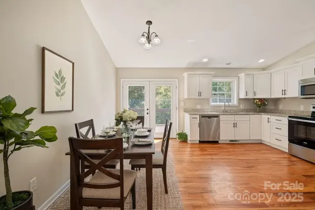 a kitchen with granite countertop wooden floor dining table and chairs