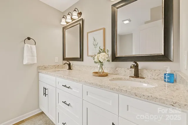 a bathroom with double sink and a mirror