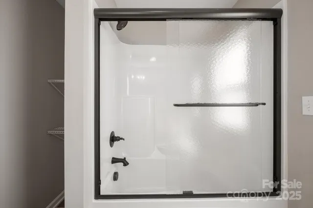 a bathroom with a glass shower door