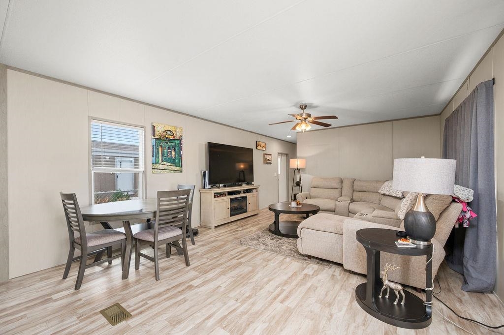 271 Clements Way Fruita, CO 81521 - Photo 4 of 26 a living room with furniture a flat screen tv and kitchen view