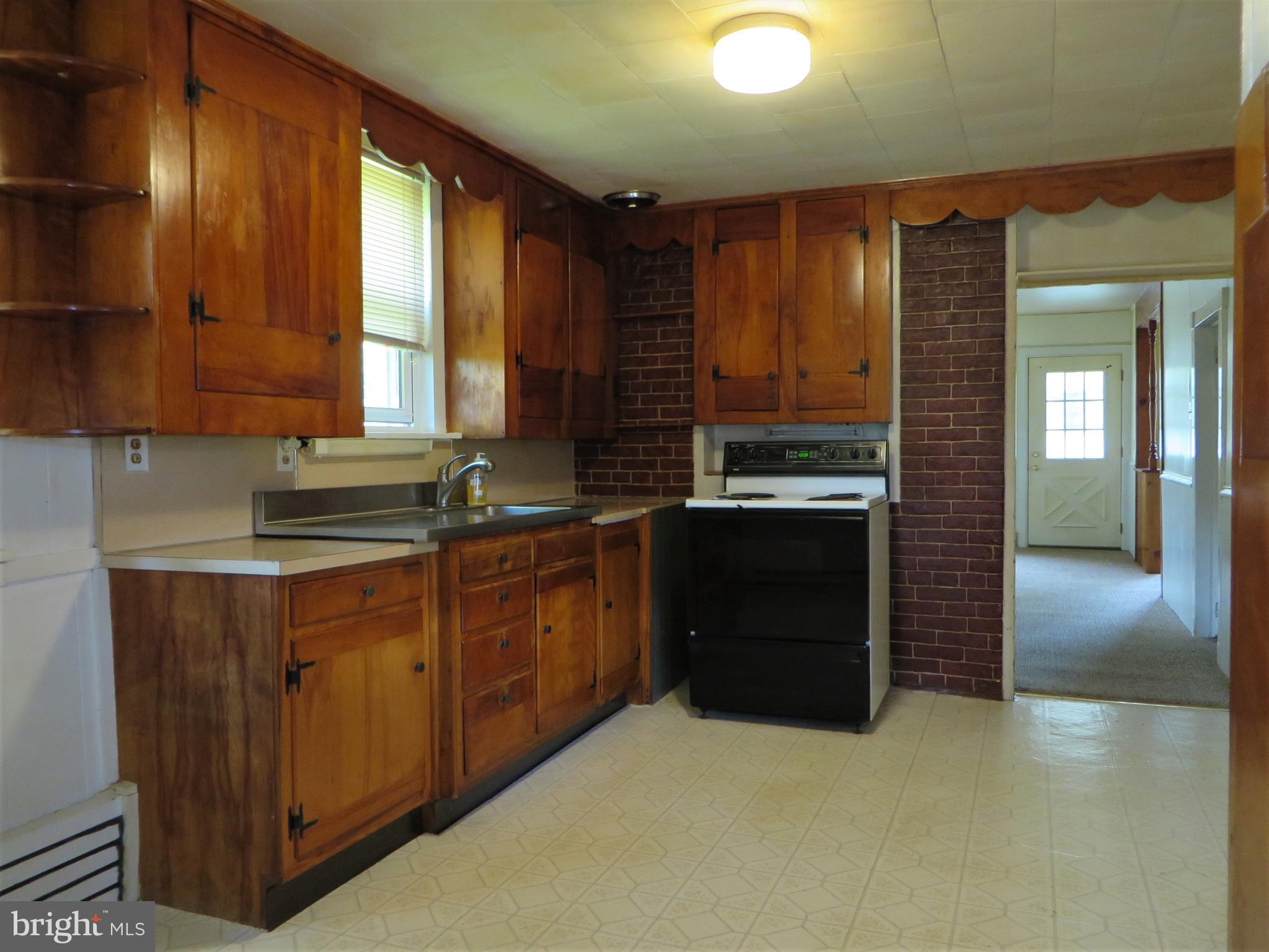 110 Race Street Lititz, PA 17543 - Photo 9 of 25 a kitchen with stainless steel appliances granite countertop a stove a sink and a microwave