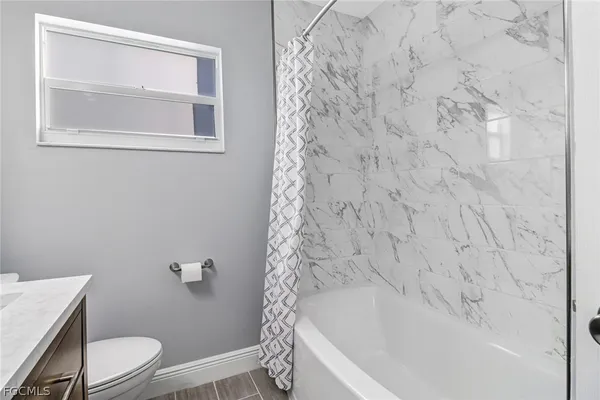 a bathroom with a toilet and shower