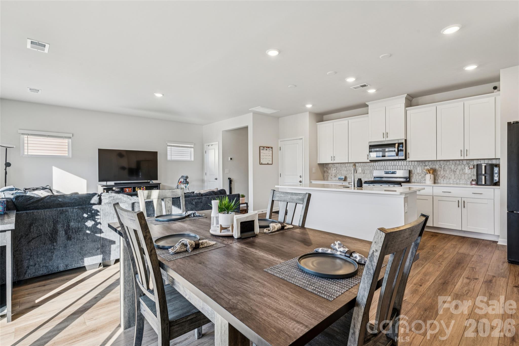 309 Olympia Way York, SC 29745 - Photo 11 of 46 a kitchen with a dining table chairs and a counter top space
