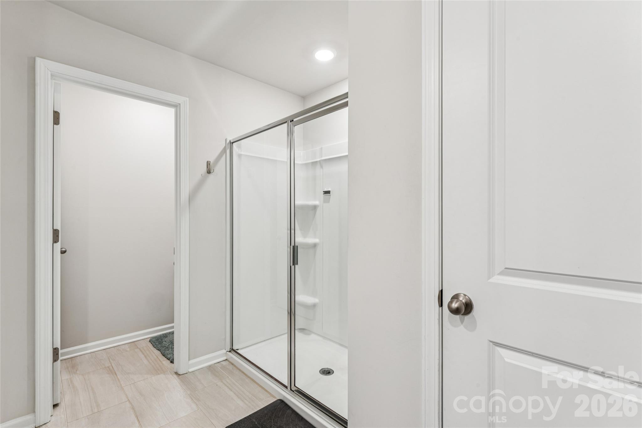 309 Olympia Way York, SC 29745 - Photo 26 of 46 a bathroom with a shower and a glass door