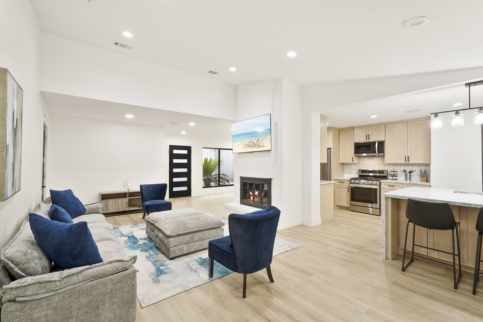 a living room with stainless steel appliances kitchen island granite countertop furniture and a kitchen view