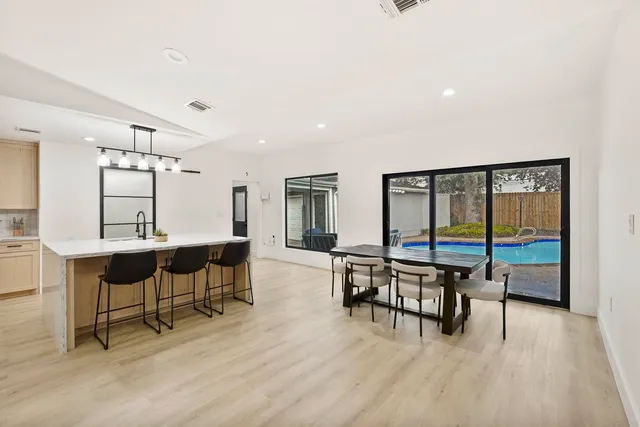 a view of a a dining room with furniture window and wooden floor