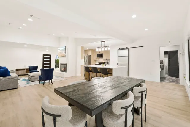 a view of a dining room with furniture and wooden floor