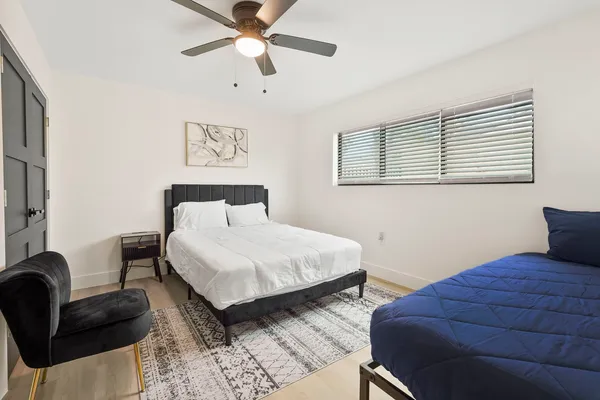 a bedroom with a bed and a couch