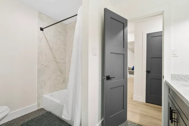 a bathroom with a shower and a sink