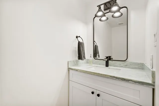 a bathroom with a sink and mirror