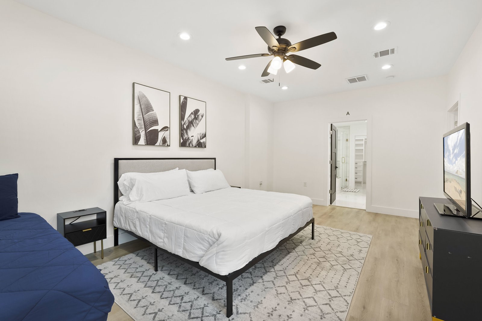 3327 Freshmeadows Drive Houston, TX 77063 - Photo 25 of 35 a bedroom with a large bed and a flat screen tv