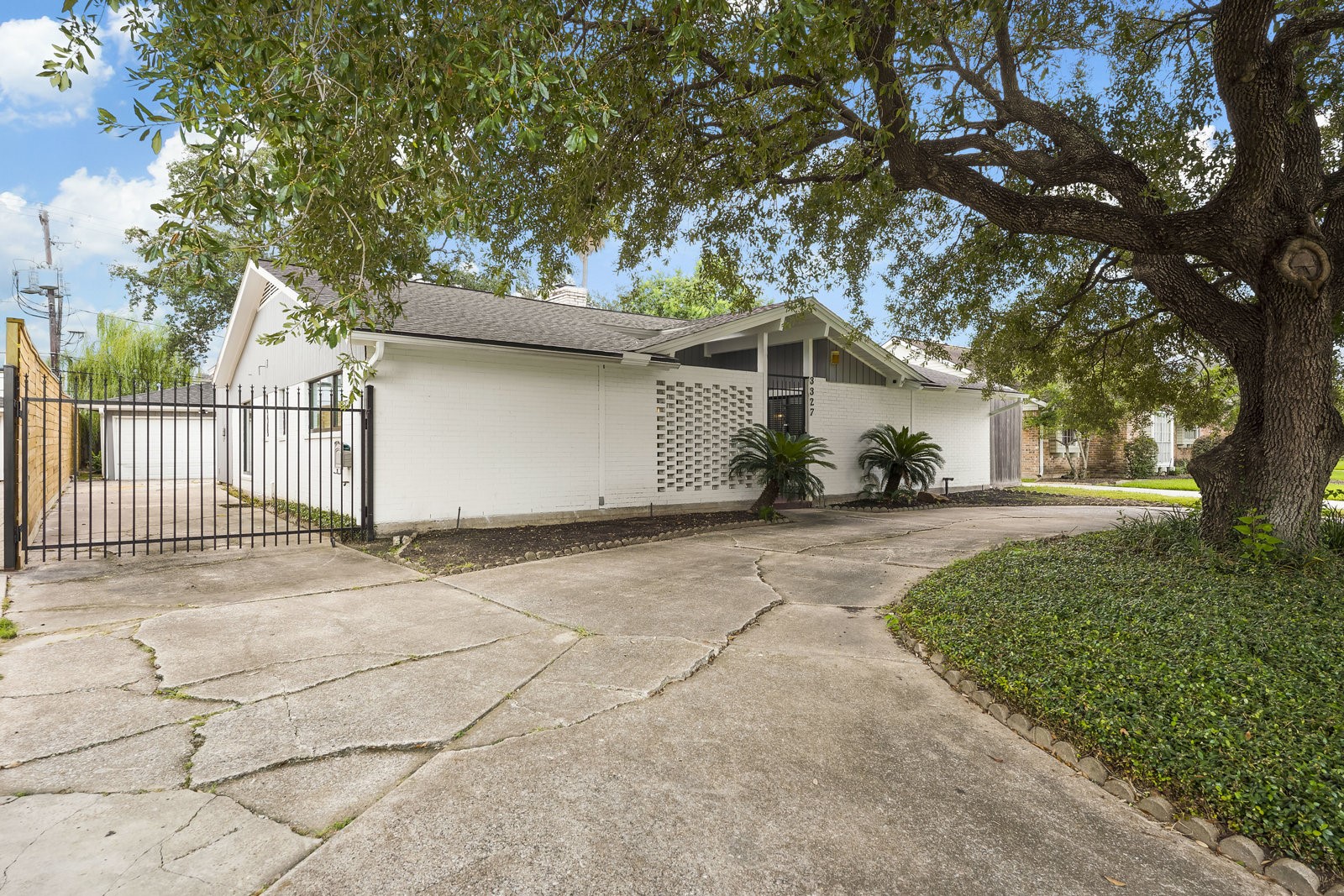 3327 Freshmeadows Drive Houston, TX 77063 - Photo 30 of 35 a front view of a house with a yard and garage
