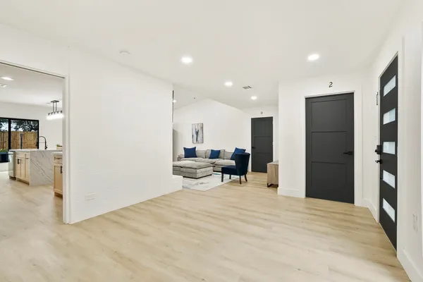a view of a livingroom with a flat screen tv and kitchen view