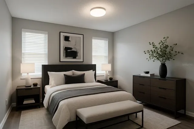 a bedroom with a bed and a potted plant