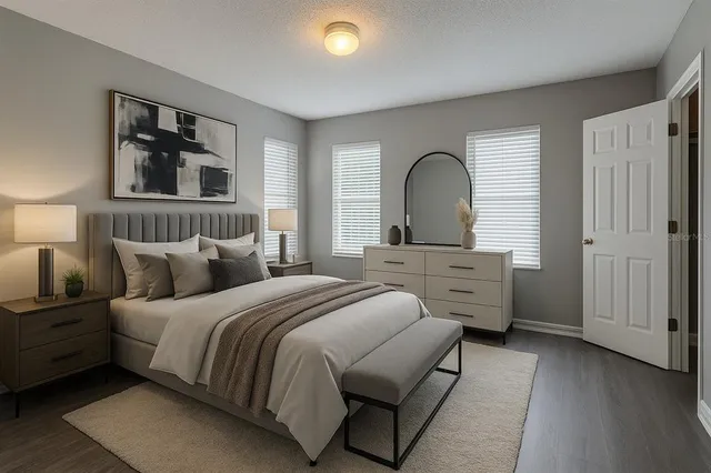 a bedroom with a bed and a large window