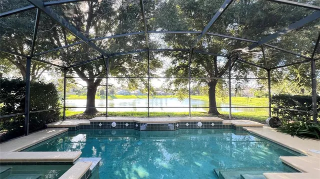 a view of swimming pool with a patio and a yard