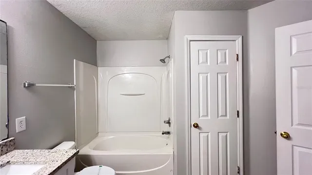 a bathroom with a toilet sink and a mirror