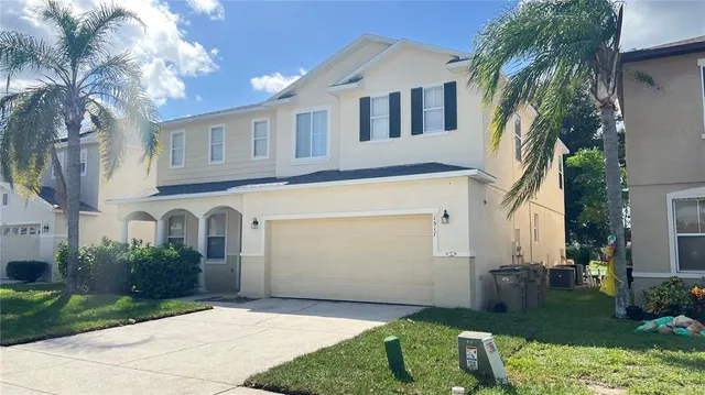 a front view of a house with a yard and garage