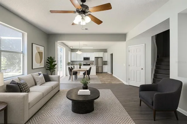 a living room with furniture and a chandelier