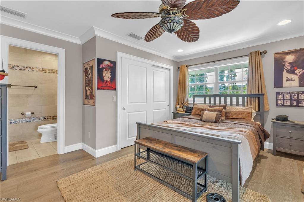 3001 50th Street Southwest Naples, FL 34116 - Photo 22 of 46 a bedroom with a bed and a chandelier