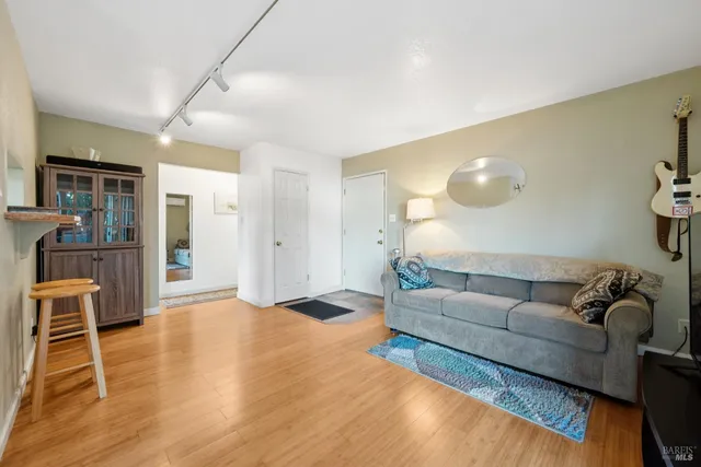 a living room with furniture and wooden floor
