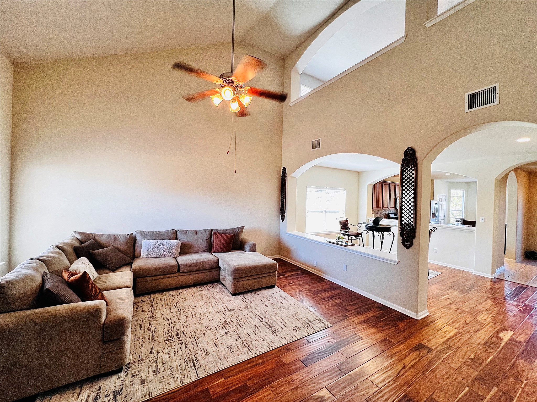 a living room with furniture and a wooden floor