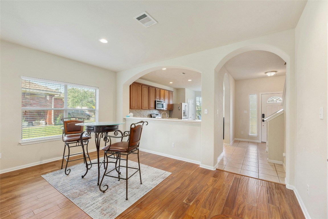 18401 Masi Loop Pflugerville, TX 78660 - Photo 12 of 29 Dining space with light wood finished floors, arched walkways, and recessed lighting