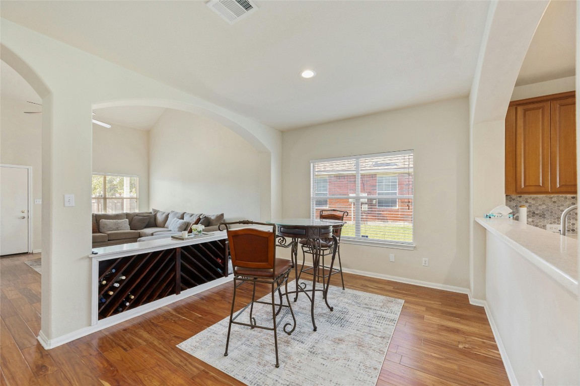 18401 Masi Loop Pflugerville, TX 78660 - Photo 13 of 29 Dining room featuring arched walkways, light wood-style flooring, and recessed lighting