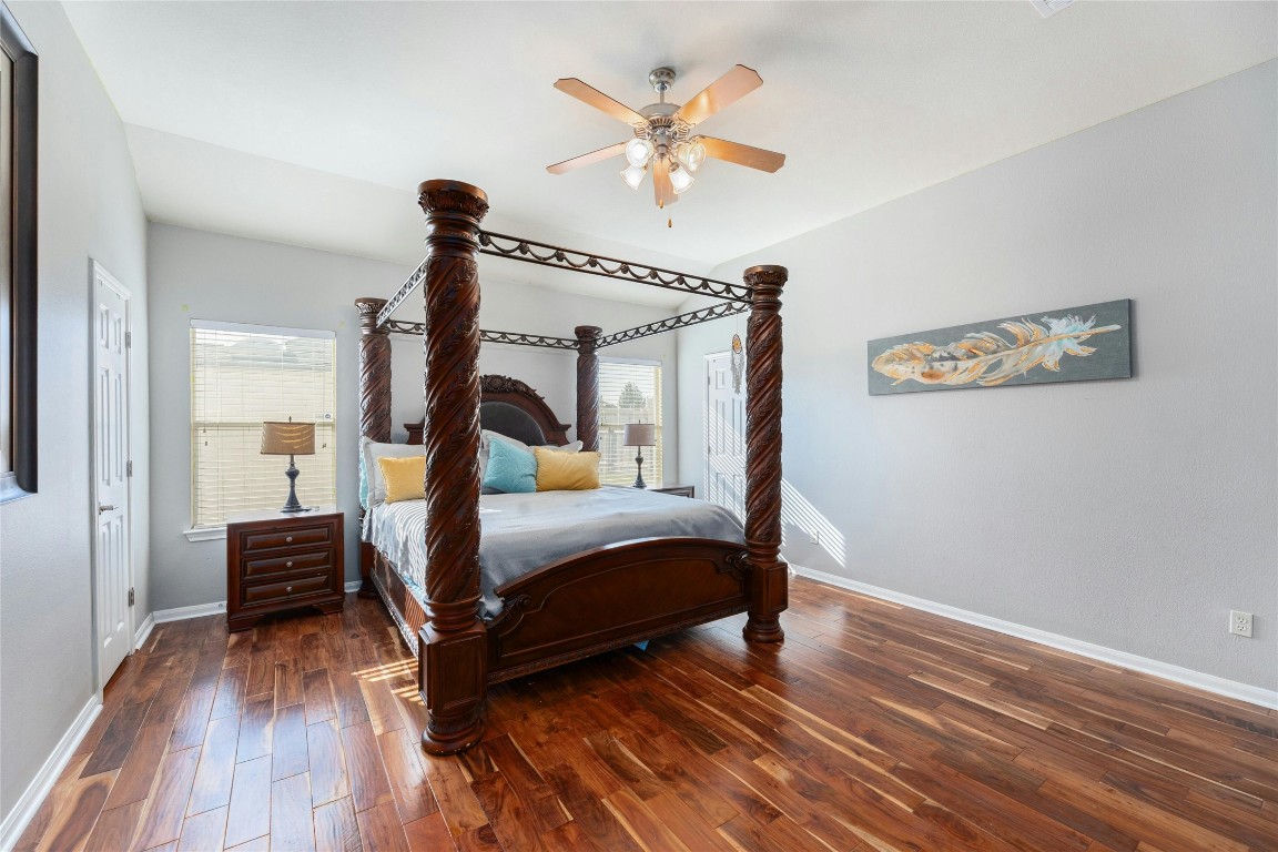 18401 Masi Loop Pflugerville, TX 78660 - Photo 16 of 29 Bedroom with multiple windows, hardwood / wood-style floors, and ceiling fan