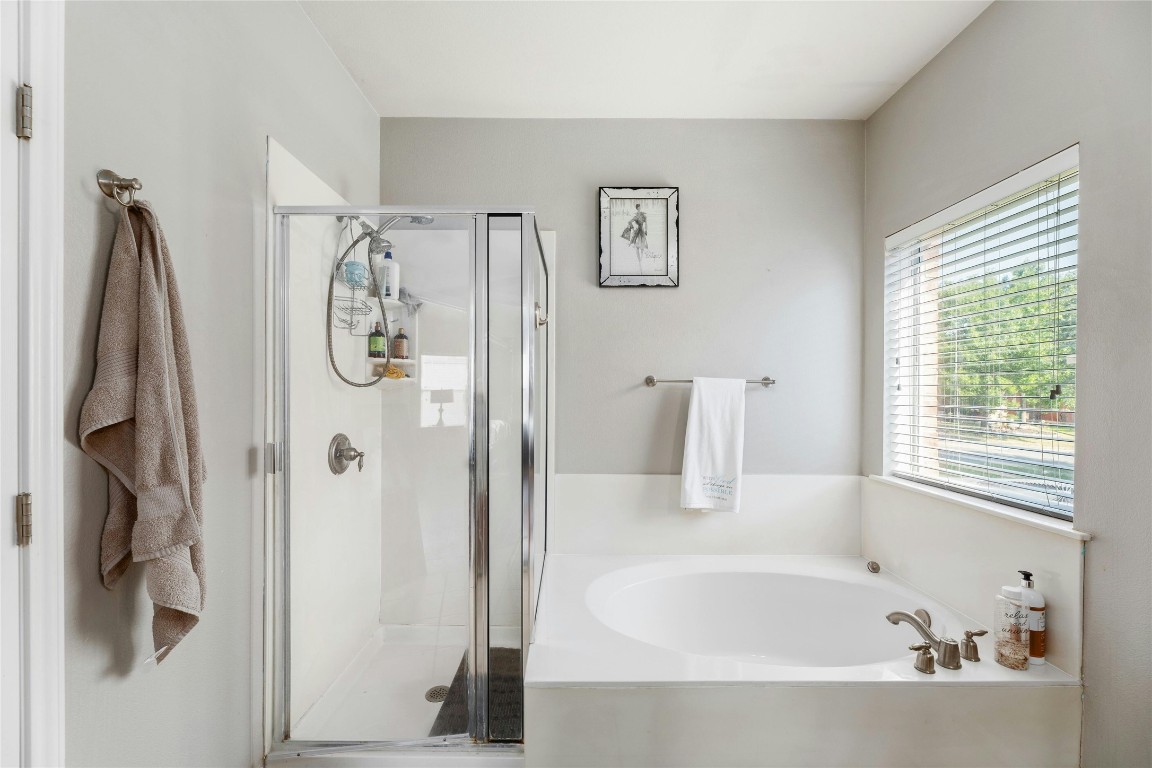 18401 Masi Loop Pflugerville, TX 78660 - Photo 17 of 29 Bathroom with a garden tub and a shower stall