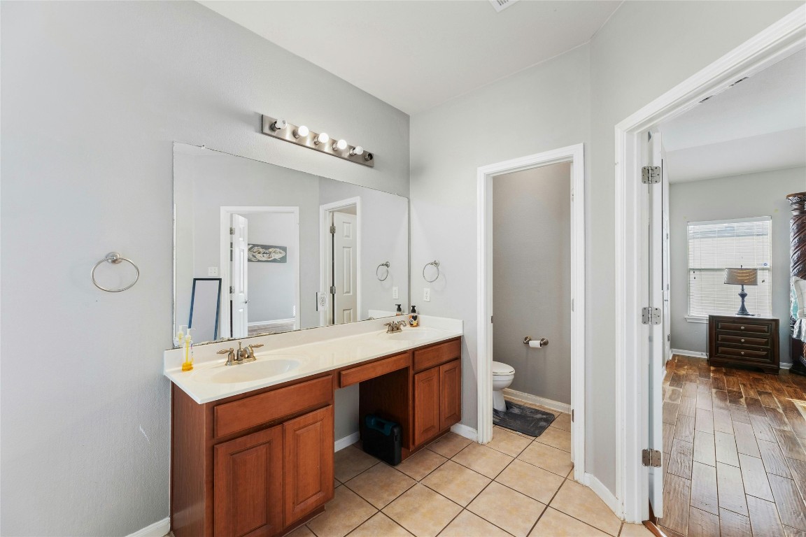 18401 Masi Loop Pflugerville, TX 78660 - Photo 18 of 29 Bathroom with double vanity and tile patterned flooring